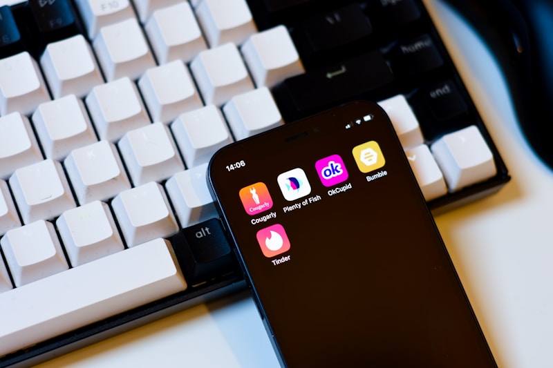 a cell phone sitting next to a keyboard